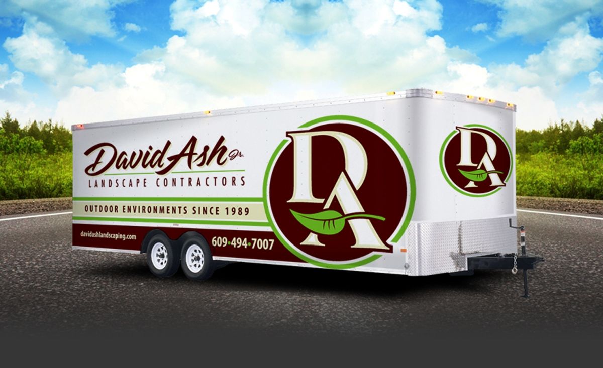 Customizable trailer decals featuring a company logo tailored to various work environments.